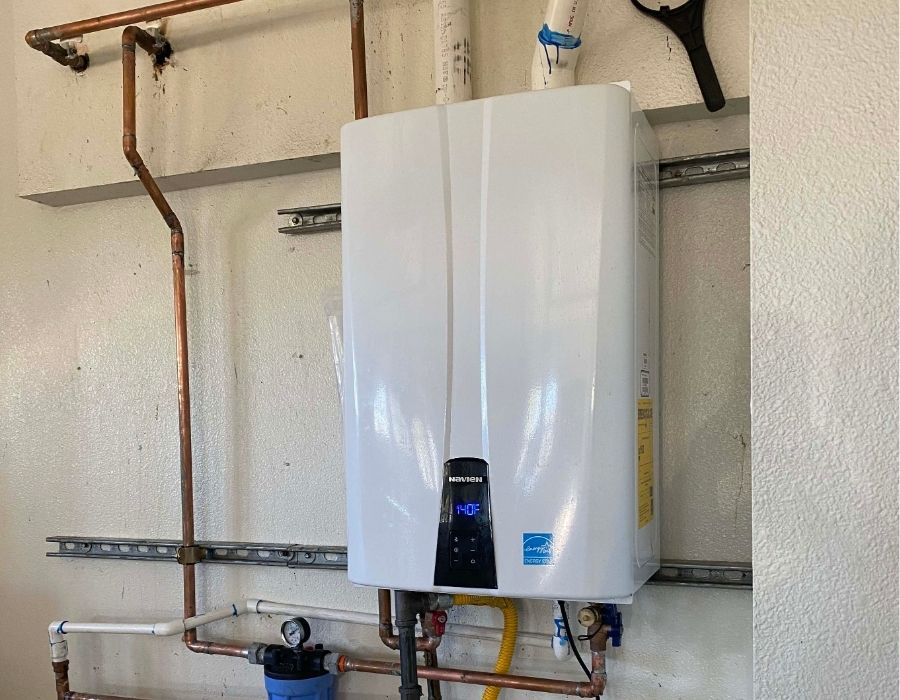 tankless-water-heater-installed Installed tankless water heater with digital temperature display in a residential home plumbing system