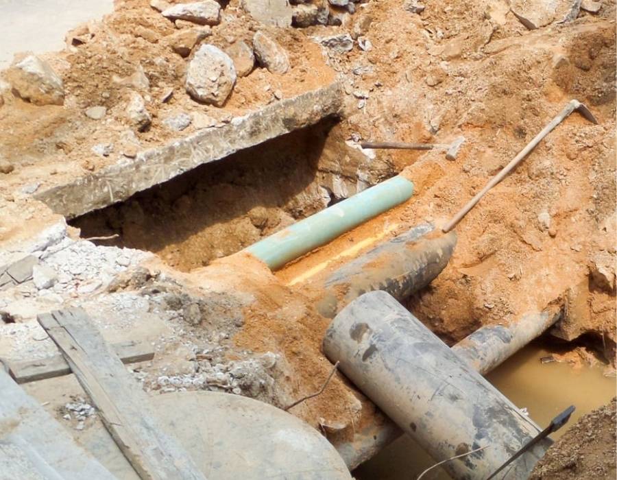 Main sewer line exposed during excavation for underground plumbing repair and pipe replacement