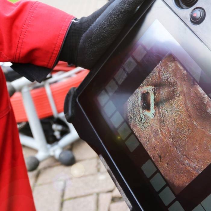 Plumber using sewer camera inspection equipment to diagnose pipe corrosion and blockages – Pro Master Services plumbing diagnostics