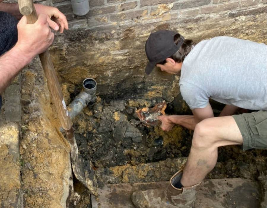 Plumber repairing broken sewer line during excavation in West Valley City – Pro Master Services